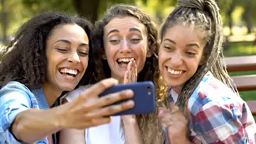 three-cheerful-friends-taking-selfie