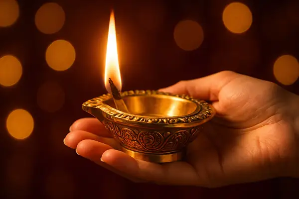 golden-brass-diya-glowing-in-hand