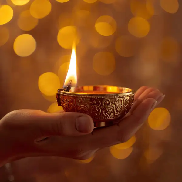 hand-holding-golden-diya-glowing